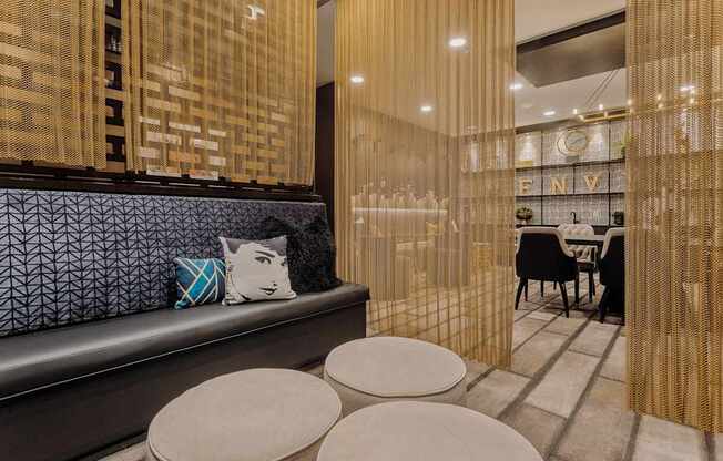 a seating area with a bench and four stools in a room with a table