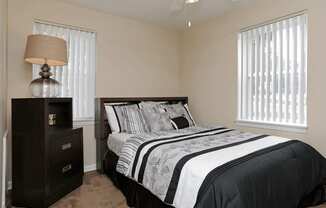 Black and white bedspread next to dresser