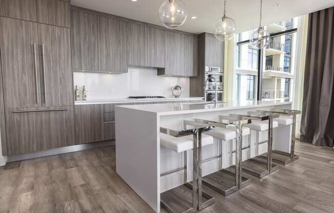 a kitchen with a large island with stools