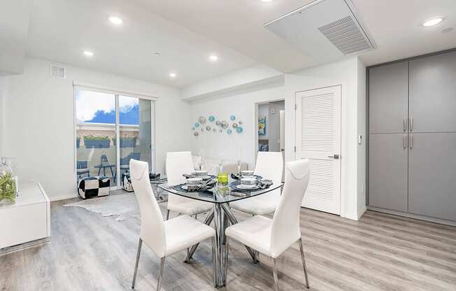 Dining area with recessed lighting, living room in the left, wood inspired flooring throughout