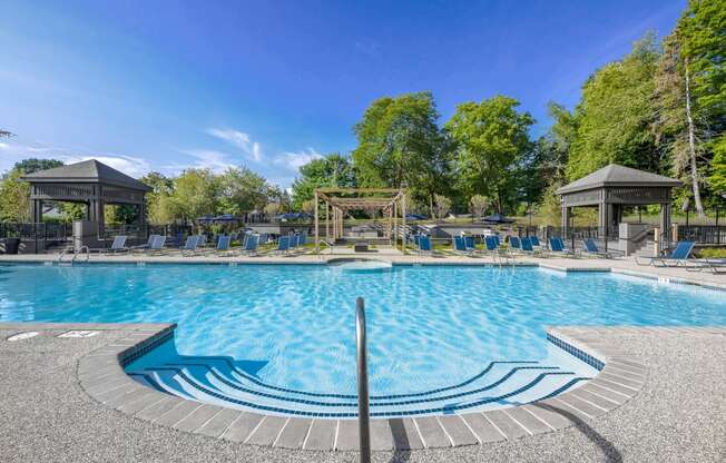 a swimming pool with chairs and gazebos at the resort at governors island  at Butternut Ridge, North Olmsted, Ohio