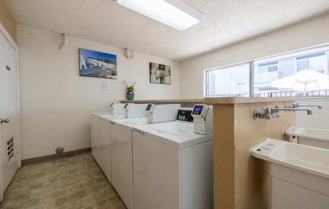 laundry room with washer and dryer and sink at the preserve apartments at Campbell West Apartments, Campbell, CA 95008