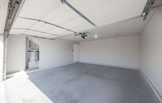 A large Garage with a grey floor and white walls.