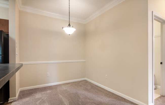 Model apartment dining area beside the kitchen at Angel Landing Apartment Homes in Pensacola, FL