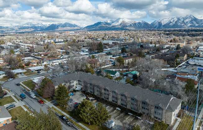 an aerial view of a city with mountains in the background