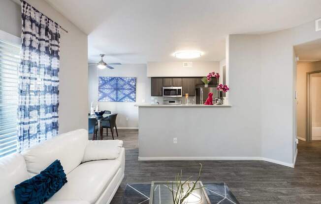 a living room and kitchen with a couch and a table
