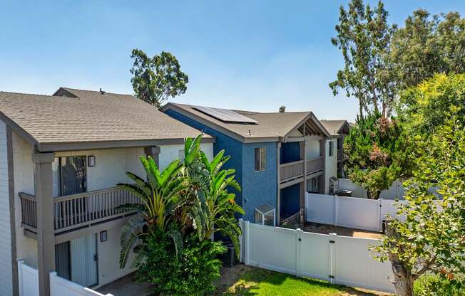Townhomes with individual lush green yards.