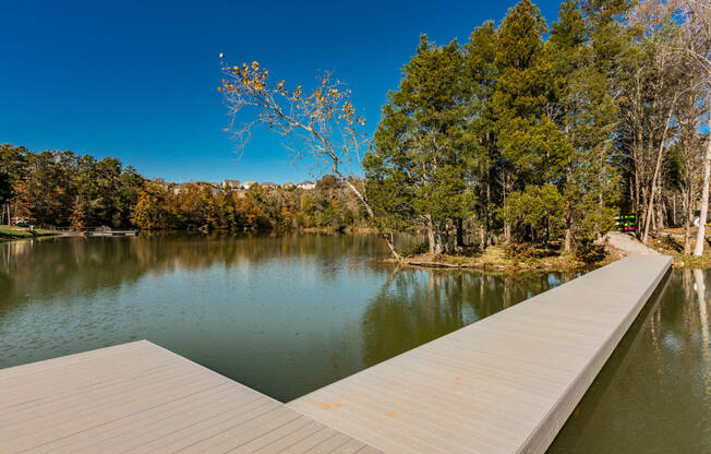 a dock on a lake with trees in the background at Village at Westland Cove Apartments, Knoxville, 37922