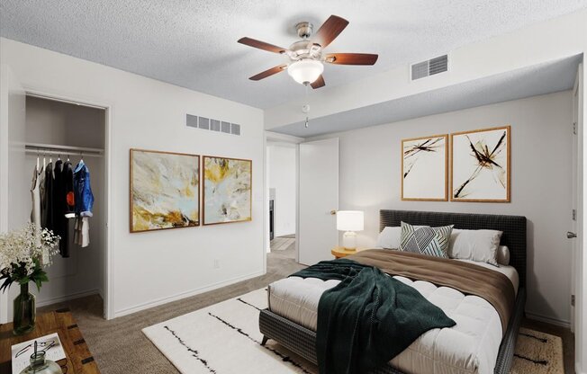 an empty bedroom with a bed and a ceiling fan