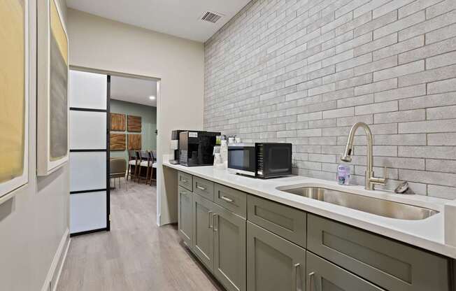 Flatiron West Trade Apartments office complimentary coffee maker, microwave and stainless steel sink