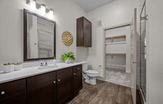 A bathroom with a brown cabinet and a white sink.