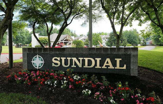 a sign for sundial in front of a park