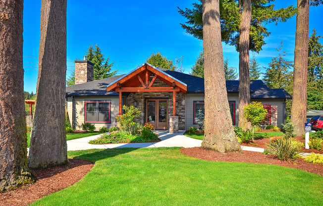 a home with large trees in front of it