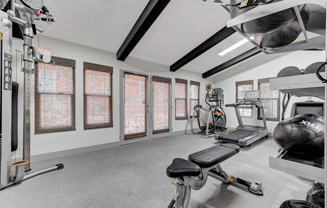 A well-equipped home gym with a variety of exercise machines.