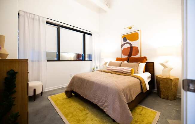 a bedroom with a bed and a large window at The Lady, Columbia, SC