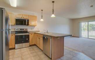 A kitchen with wooden cabinets and stainless steel appliances.