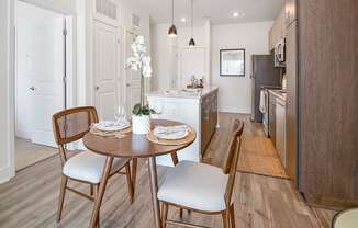 a kitchen and dining room with a table and chairs