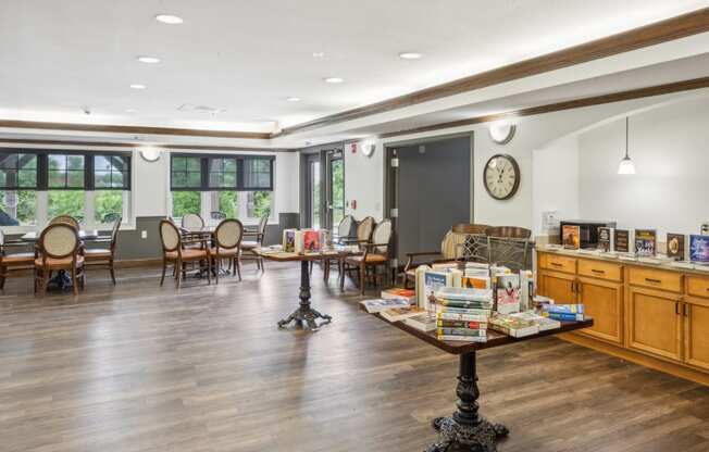 a large room with tables and chairs and a clock on the wall