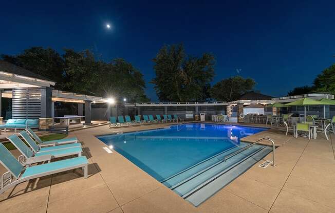 Community Swimming Pool with Pool Furniture at Essence North Dallas Apartments located in Dallas, TX.
