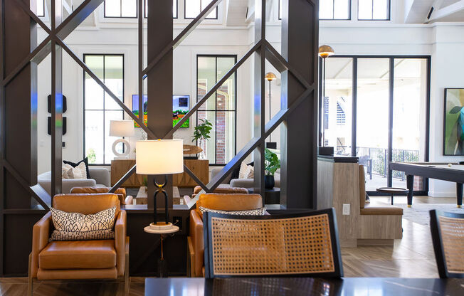 the lobby of a hotel with chairs and a table