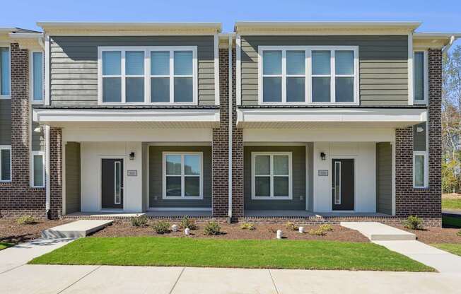 A modern two-story house with a grey and white exterior.