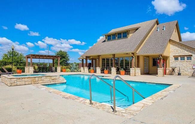 Swimming pool at Oak hollow with beach chairs and exterior building