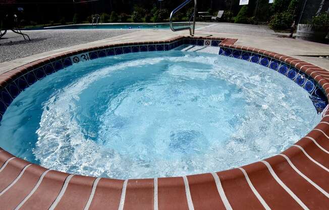 a large jacuzzi in a backyard with a pool