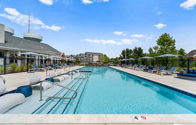 A large swimming pool with a blue tiled edge and a white line down the middle.