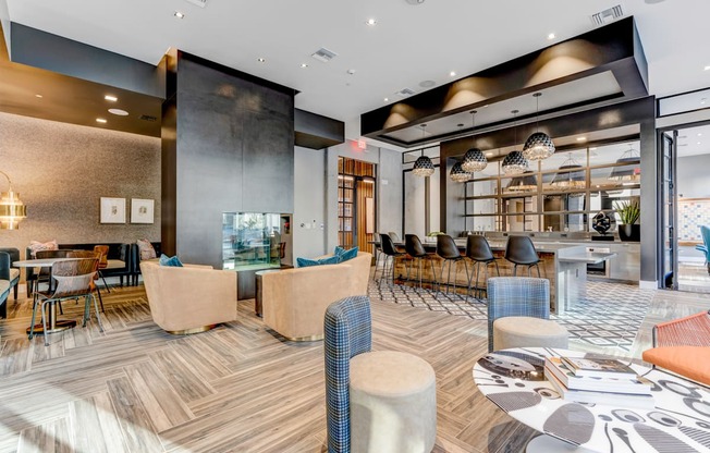 a lounge area with tables and chairs and a fireplace