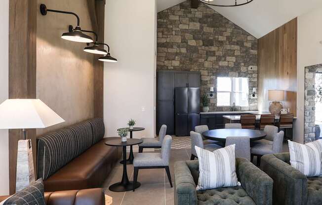 A living room with a stone wall and a large sectional sofa.