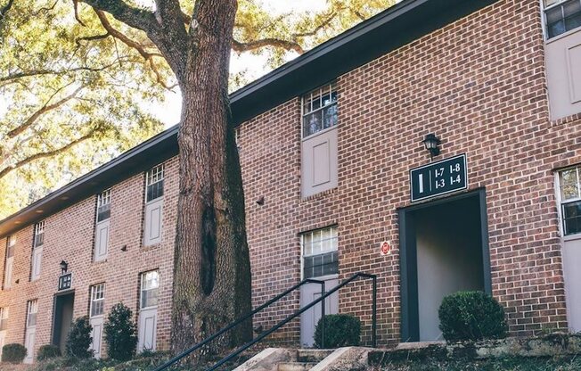 a brick building with a tree in front of it