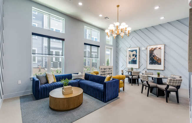 A modern living room with a blue couch and a wooden coffee table.