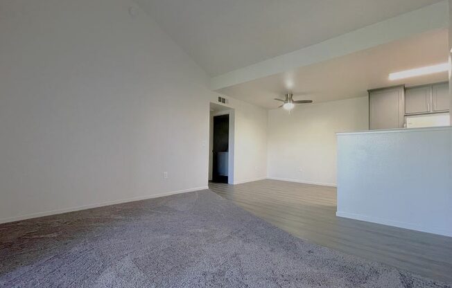 an empty living room with white walls and a concrete floor