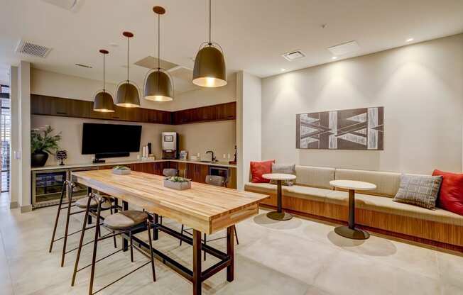 a kitchen and living room with a wooden dining table