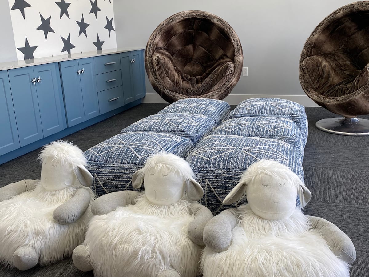 Four stuffed sheep are sitting on the floor at Portofino Vineyards Apartment, Florida