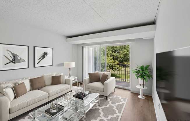 Model modern living room with a glass coffee table and a large window.