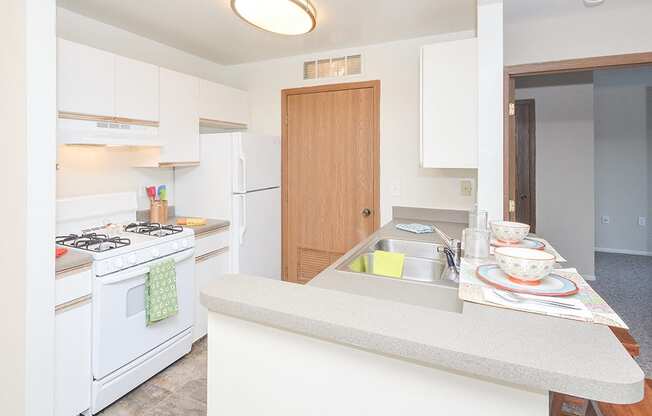 Kitchen with White Appliances and Breakfast Bar