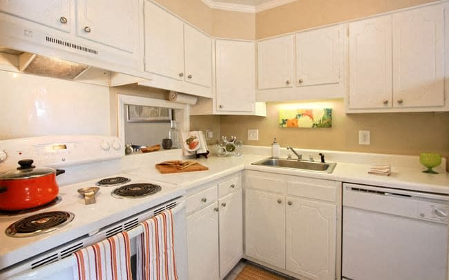 a white kitchen with white appliances and white cabinets