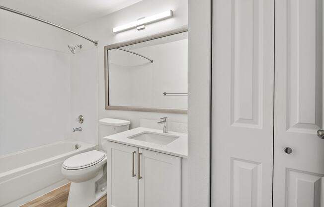 a bathroom with a toilet sink and bathtub