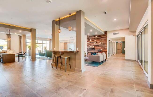 A spacious living room with a kitchen area in the background.