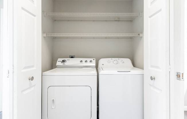 Pet-Friendly Apartments in Houston, TX – Westchase Forest – Photo of a small laundry room with a washer and dryer