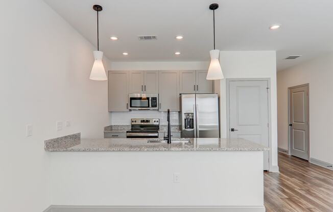 a kitchen with white cabinets and a counter top