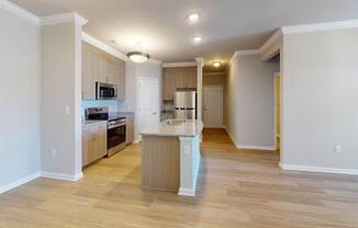 A kitchen with a white counter and luxury vinyl floors.