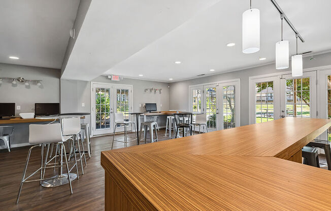 a large bar with chairs and tables in a room with windows