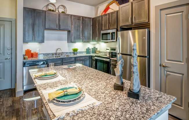 a kitchen with granite counter tops and stainless steel appliances