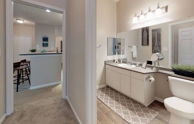 a bathroom with a toilet sink and mirror at Autumn Park Apartments, Charlotte, NC