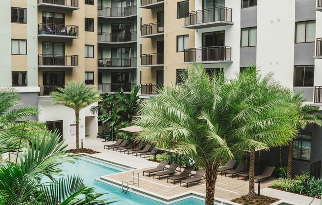 Available apartments feature balconies that offer breathtaking views of the shimmering pool below.