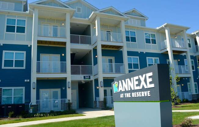Apartment complex with a sign that says Annexe at the Reserve.