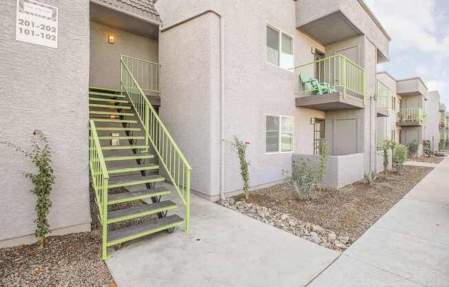 A building with a green staircase outside.