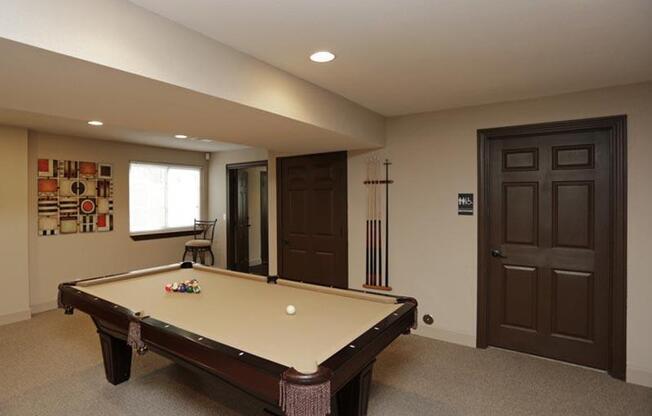 a pool table in a room with two doors